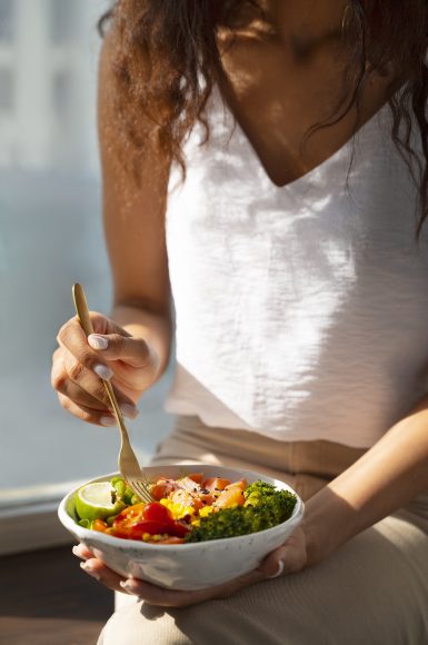 person-eating-salmon-bowl